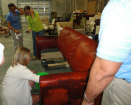 Technicians repairing leather sofa